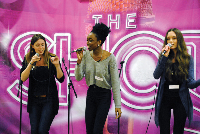 From left: Students Jessica Bell from Wilfrid Laurier, Pam Olayemi from Wilfrid Laurier, and Melissa Koehler from University of Waterloo sing during a mentoring session at the Waterloo Inn as part of The Shot vocal contest. Bell and Olayemi are two of the eight finalists.